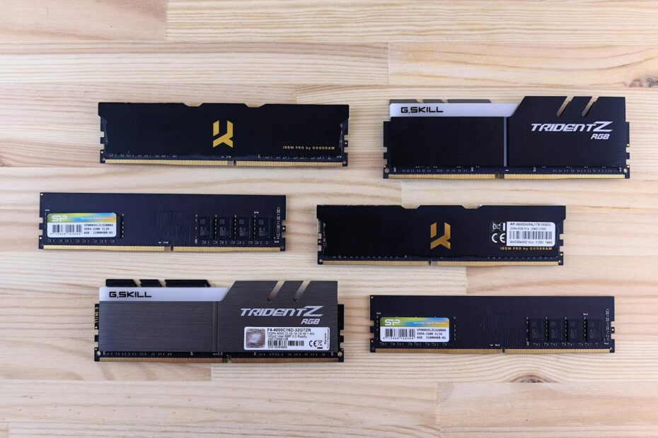 Top view of various RAM sticks arranged on a wooden surface, showcasing computer memory technology.