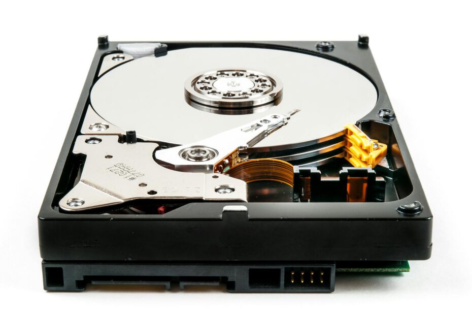 Detailed view of an open hard drive showcasing internal components against a white backdrop.